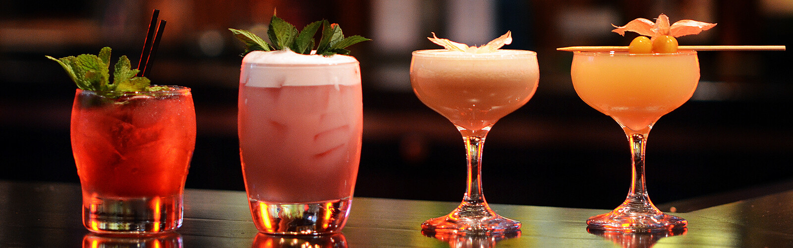 two glasses with drinks on a table